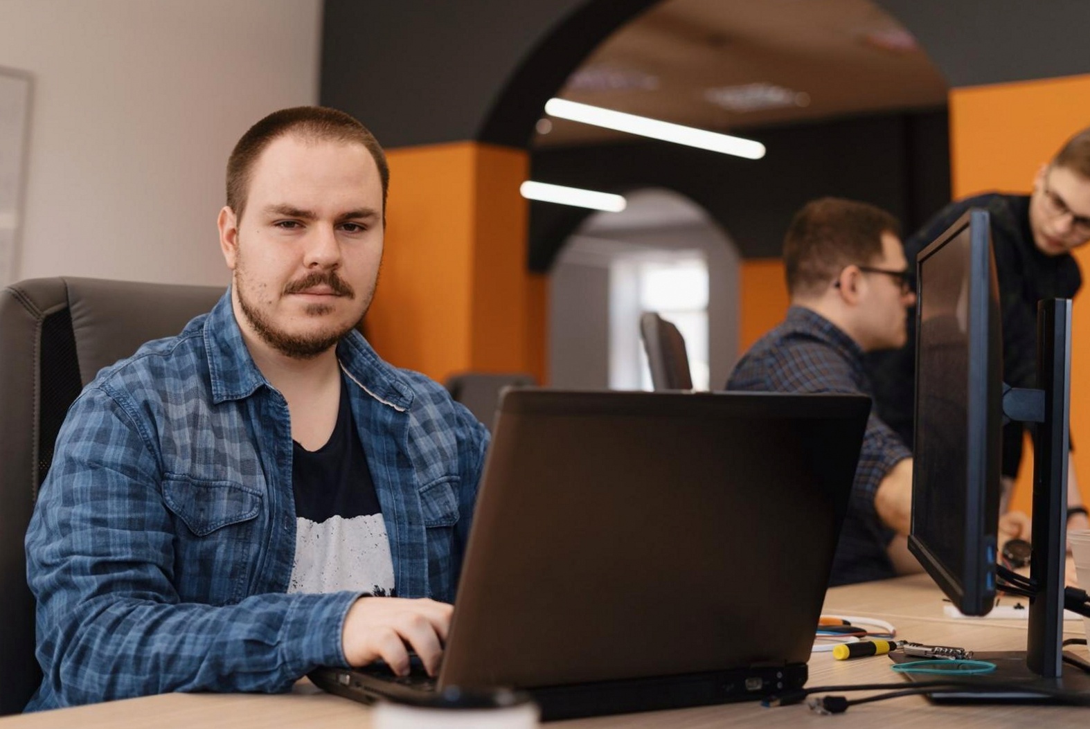 Designer reviewing mobile app interface wireframes on a large display